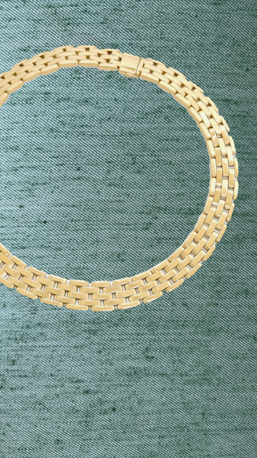Gold brick-link collar necklace on green silk